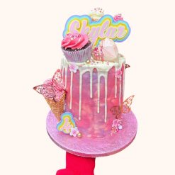The 16cm Fairytale Rainbow cake topper displayed on a real cake show scale and its bright, harmonious colours.